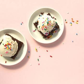 Two plates containing a Fiber One brownie topped with a scoop of vanilla ice cream with colorful sprinkles - Link to social post